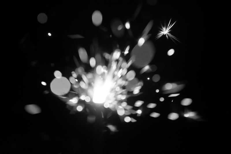 Black and white sparkler explosion of bright white sparks with bokeh