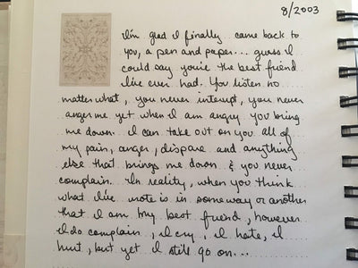 Handwritten text on an off white journal page with the date 8/2003 in the top right